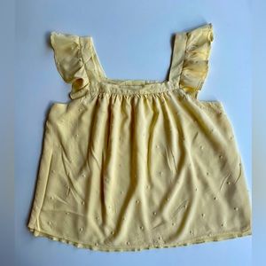 Francesca’s light yellow camisole.